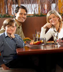 Happy Family Sitting in Restaurant